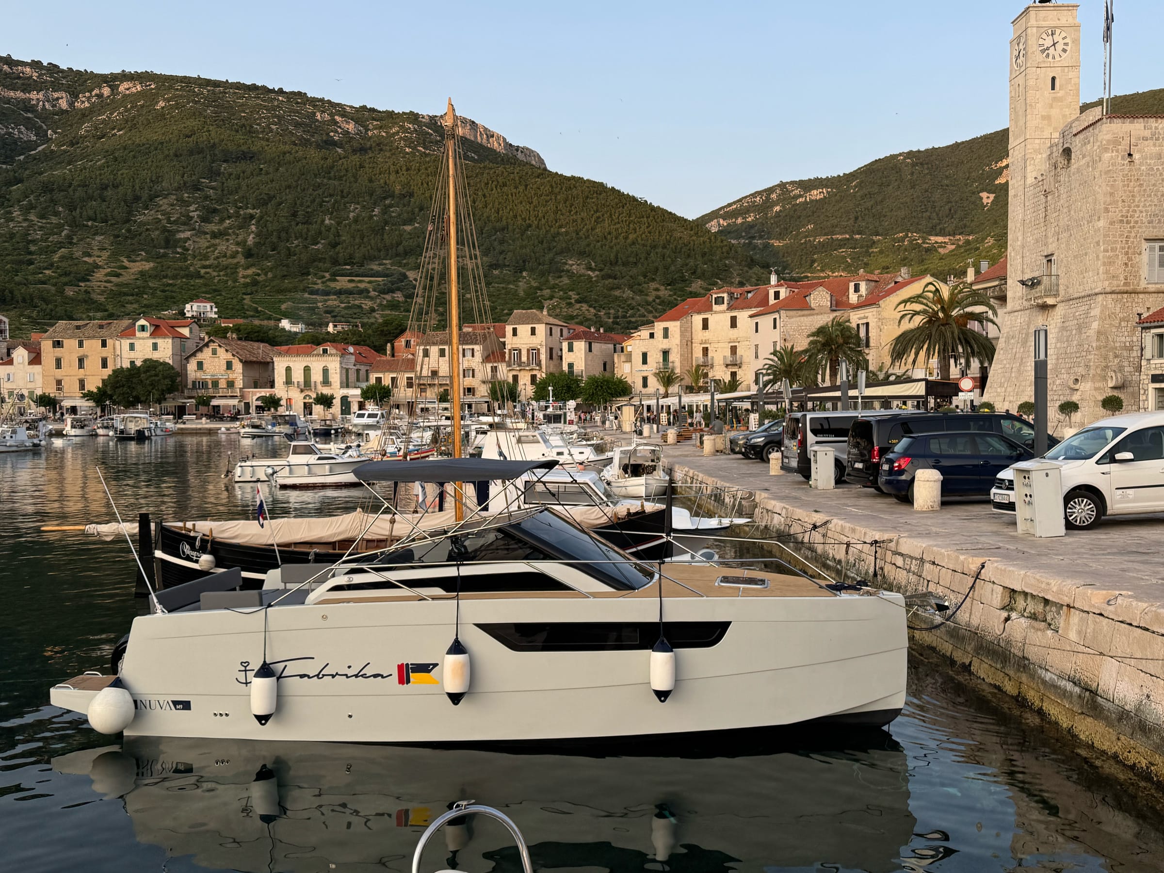 The Nuva M9 moored in Vis town harbour at golden hour